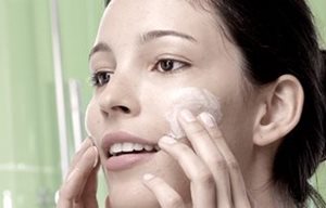 Image of woman applying Eucerin Toner to her face