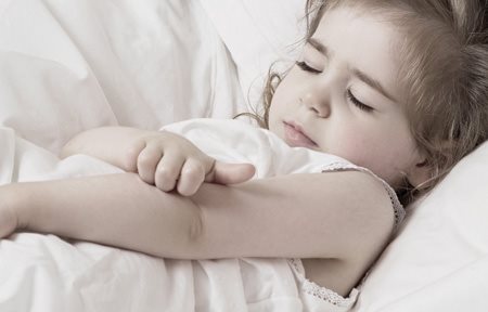 Little girl scratching the crook of her arm.