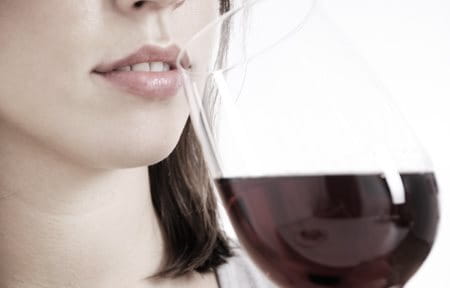 Woman drinking a glass of red wine.