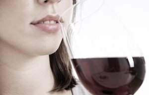Woman drinking a glass of red wine.