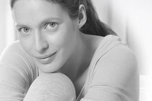 Woman leaning her head on her knee.