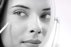 Eucerin model is using spot corrector against dark spots